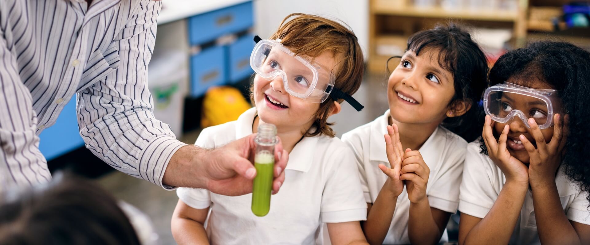 Small children smiling during a science lesson at school