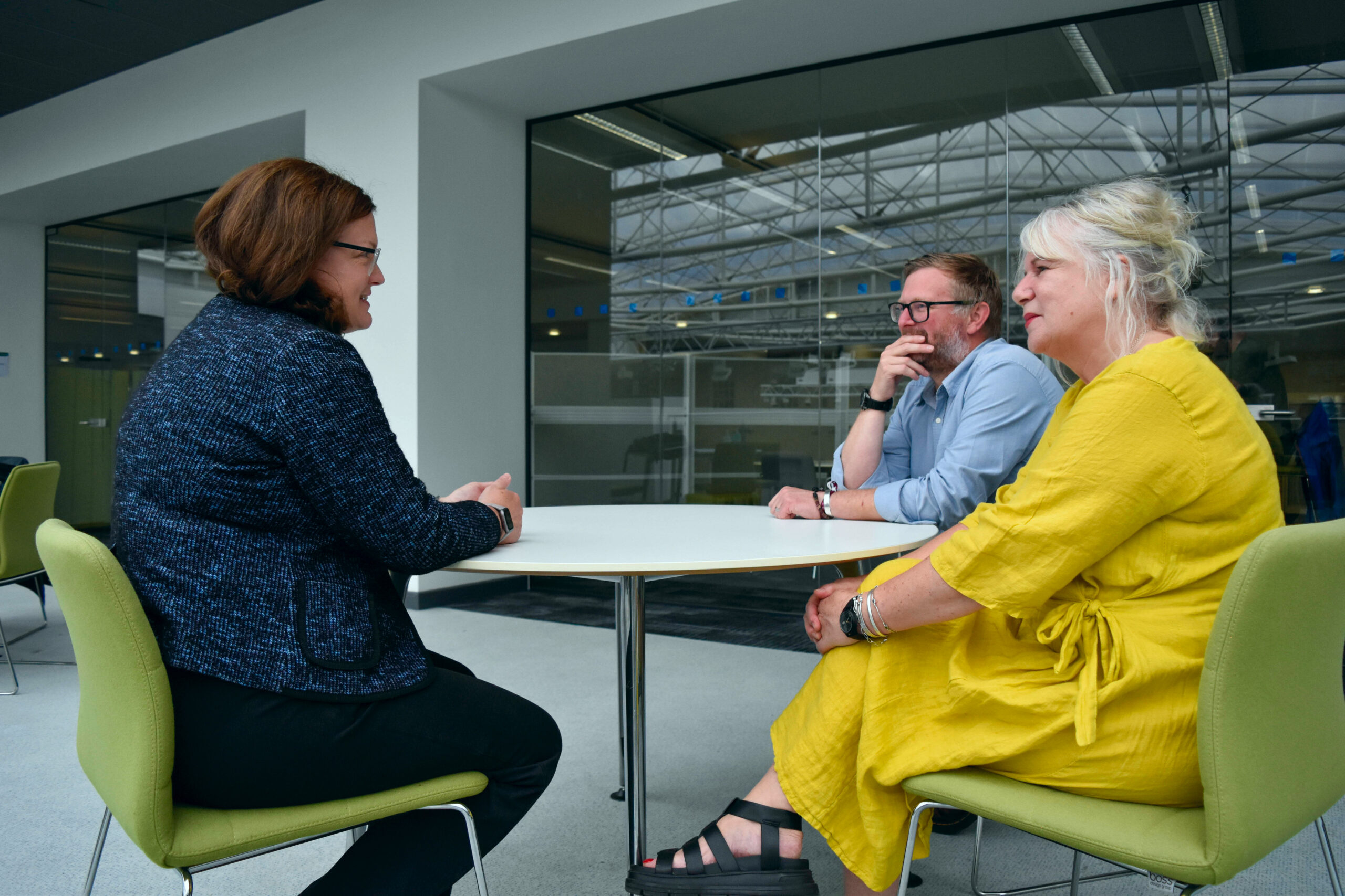 Group of staff talking around a table