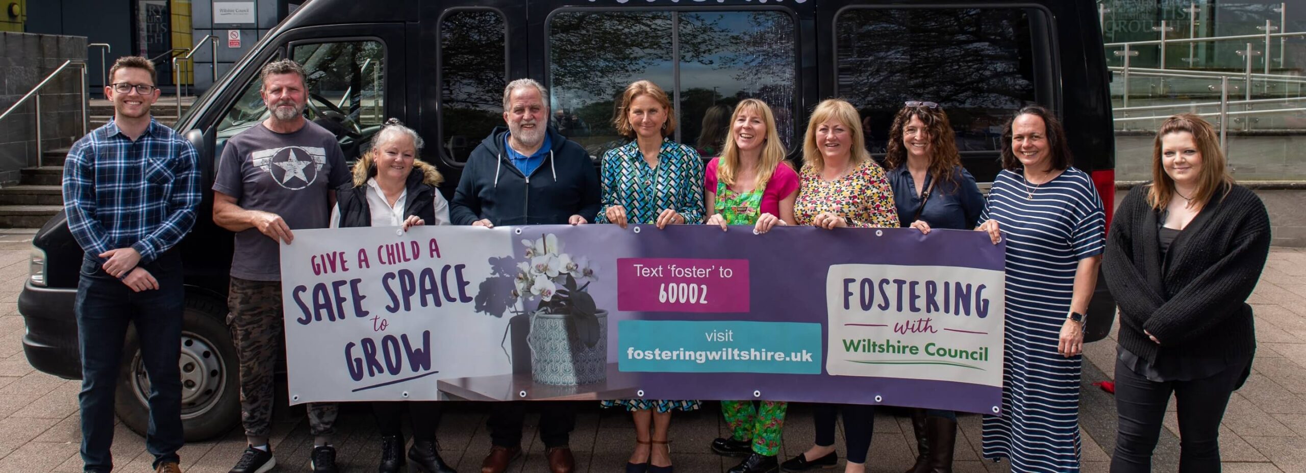 Wiltshire team holding banner